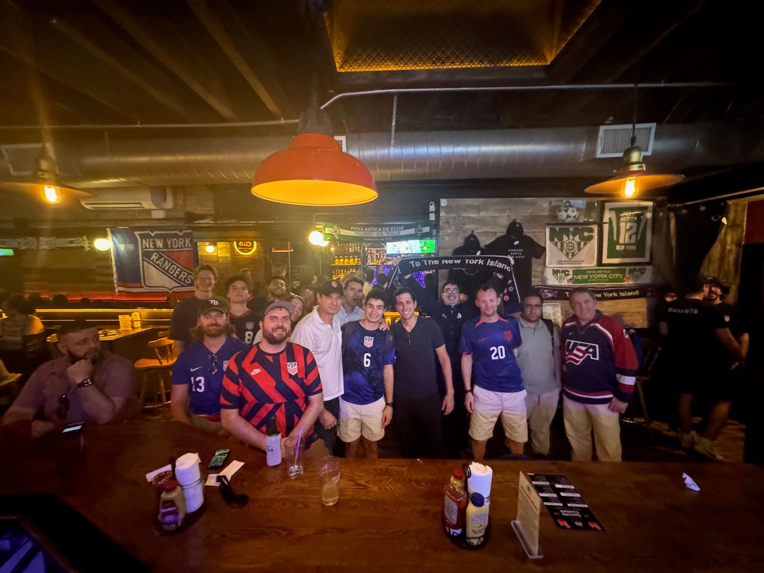 Supporters gathered at bar USA jerseys